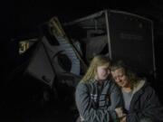 Brittaney Deaton, 17, left, comforts her mother Amber Zeleny, 53, while speaking with reporters after a severe storm passed in Johnson County near Burleson, Texas, Tuesday, April 5, 2022.  The latest round of storms to pound the South prompted a flurry of tornado warnings at the start of what forecasters said could be two days of violent weather in the region. More than 55,000 homes and businesses were without power Tuesday morning from eastern Texas to southern Mississippi after storms.