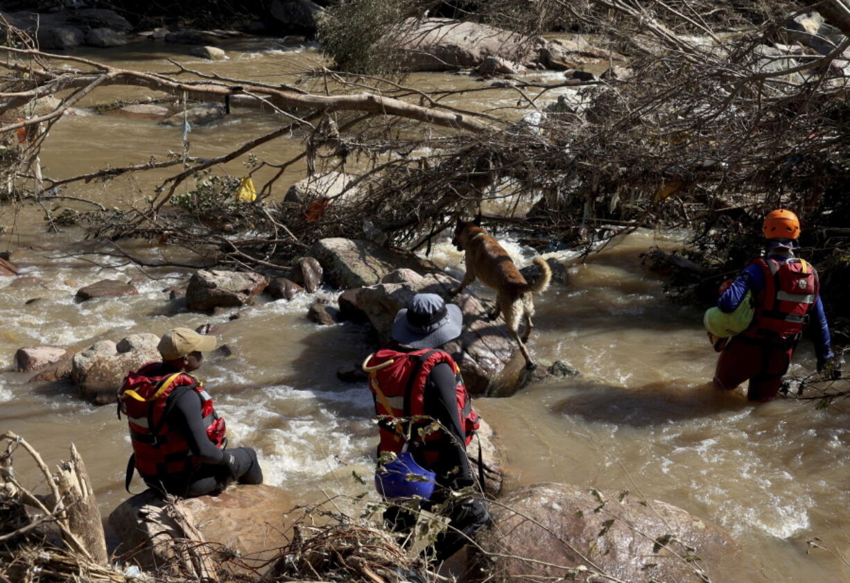 FILE - Search and rescue team looking for bodies at Umzinyathi Falls after floods, in Inanda near Durban, South Africa, Tuesday, April 19, 2022.