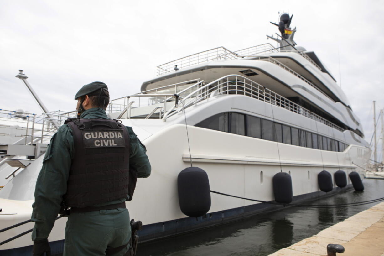 A Civil Guard stands by the yacht called Tango in Palma de Mallorca, Spain, Monday April 4, 2022. U.S. federal agents and Spain's Civil Guard are searching the yacht owned by a Russian oligarch. The yacht is among the assets linked to Viktor Vekselberg, a billionaire and close ally with Russia's President Vladimir Putin, who heads the Moscow-based Renova Group, a conglomerate encompassing metals, mining, tech and other assets, according to U.S. Treasury Department documents. All of Vekselberg's assets in the U.S. are frozen and U.S. companies are forbidden from doing business with him and his entities.