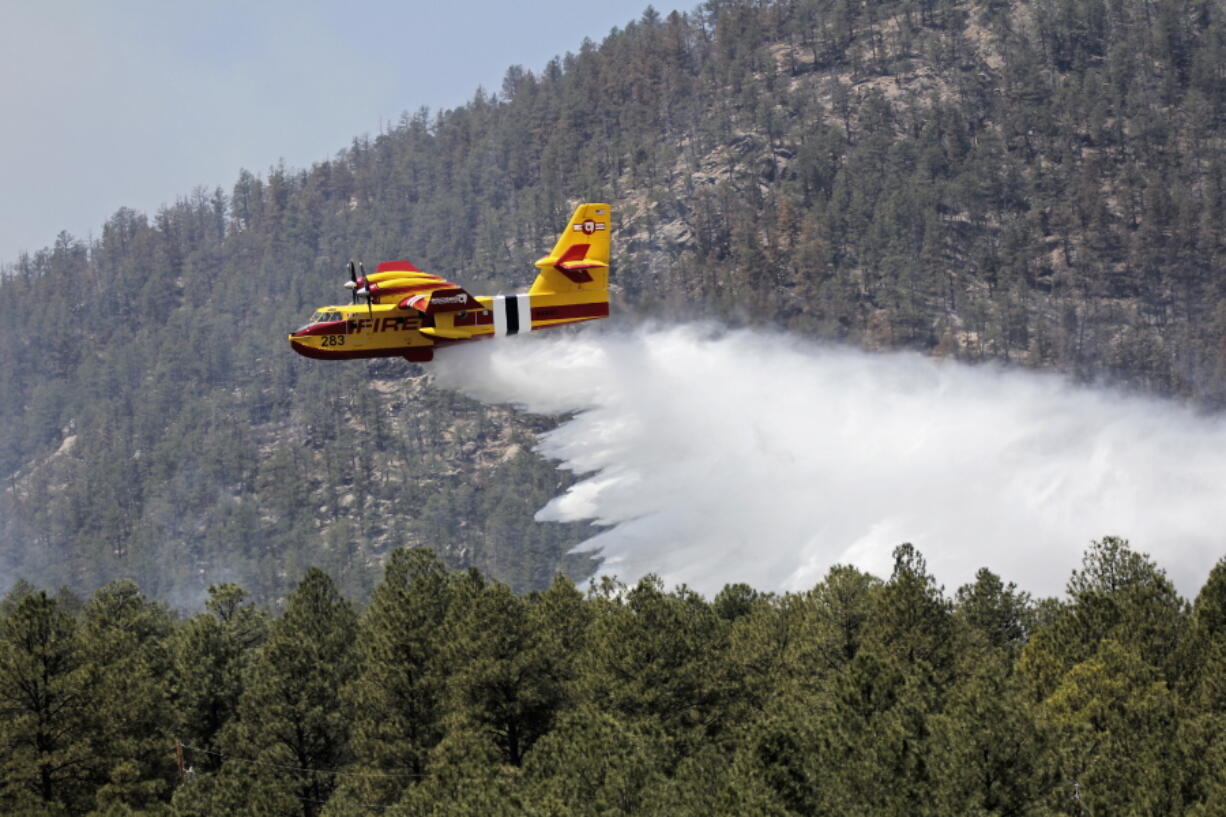 An aircraft known as a "super scooper" battles the Hermits Peak and Calf Canyon fires Thursday in the Santa Fe National Forest in New Mexico. (J. Michael Johnson/U.S.