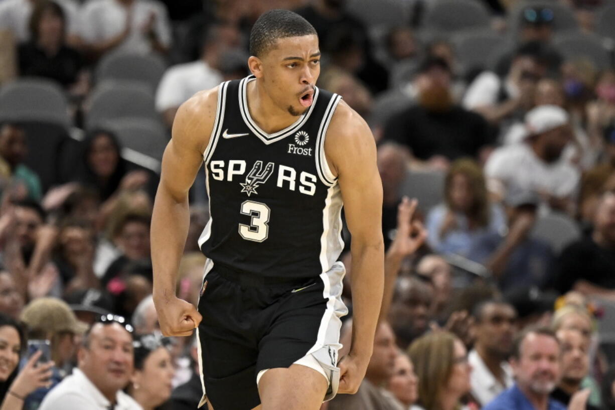 San Antonio Spurs' Keldon Johnson celebrates after a basket during the first half of an NBA basketball game against the Portland Trail Blazers on Sunday, April 3, 2022, in San Antonio.