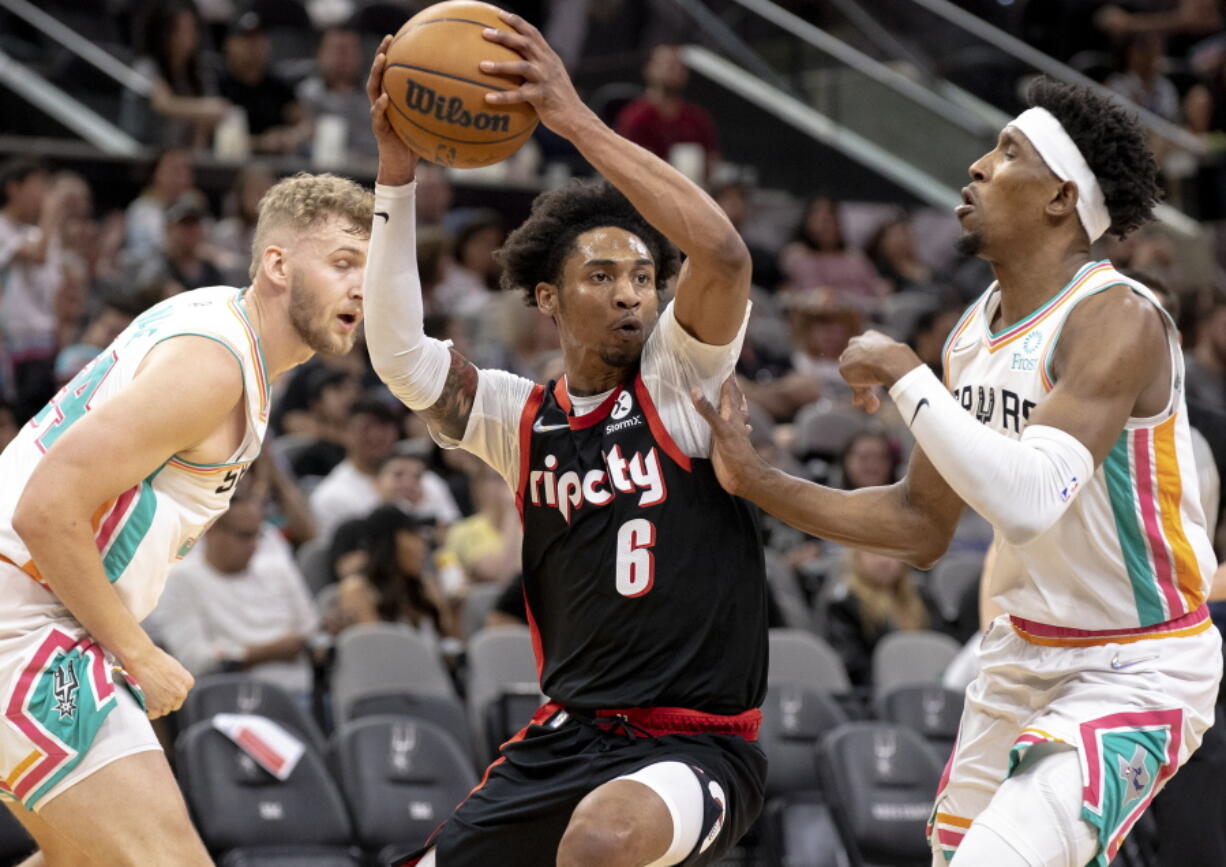 Portland Trail Blazers guard Keon Johnson (6) drives to the hoop as San Antonio Spurs guard Josh Richardson, right, defends during the first half of an NBA basketball game Friday, April 1, 2022, in San Antonio.