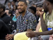 Portland Trail Blazers guard Damian Lillard sits on the bench during the second half of the team's NBA basketball game against the San Antonio Spurs on Friday, April 1, 2022, in San Antonio. Lillard is injured and out for the remainder of the season.