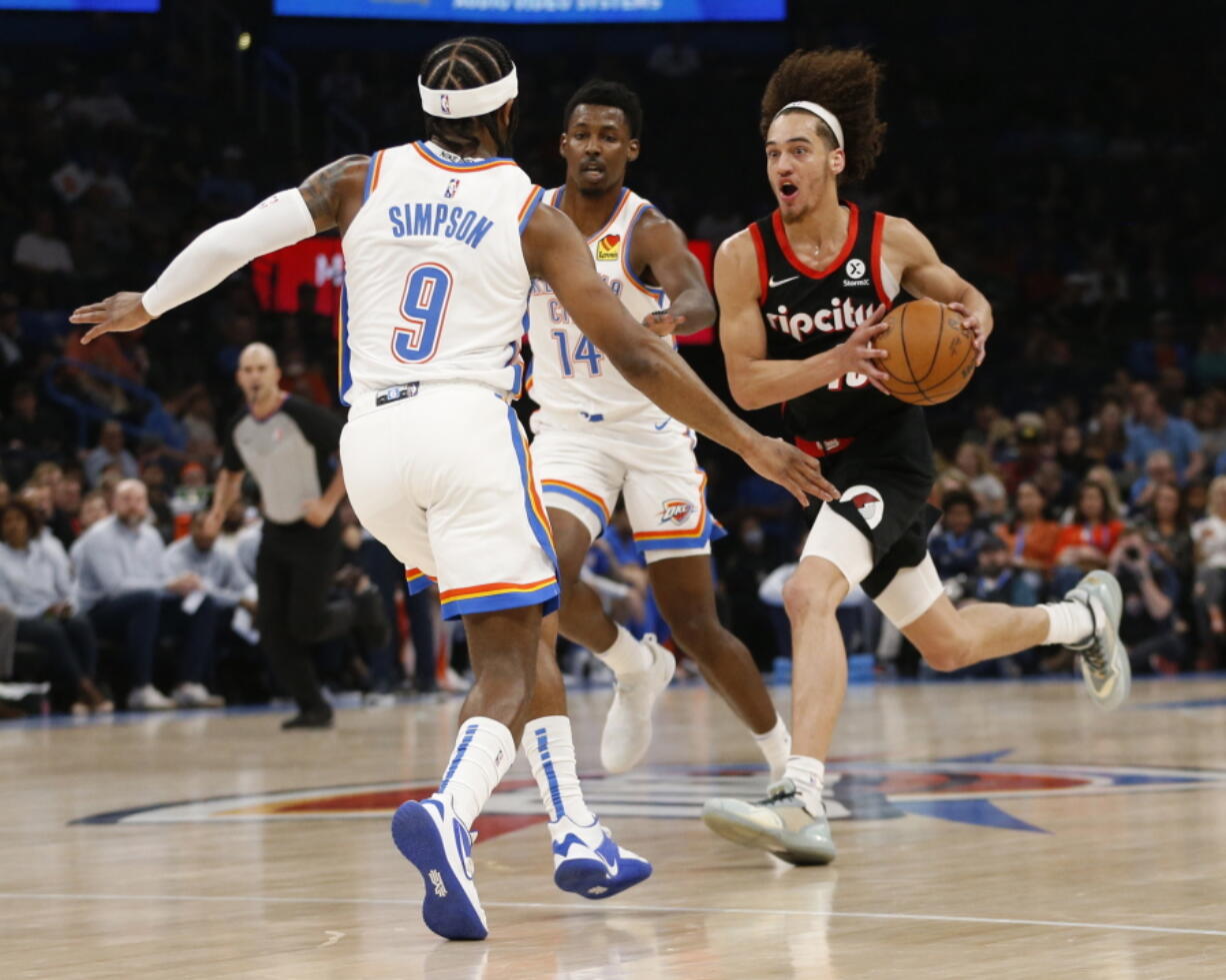 Portland Trail Blazers guard CJ Elleby (16) drives the ball against Trail Blazers guard Zavier Simpson (9) and forward Jaylen Hoard (14) during the first half of an NBA basketball game Tuesday, April 5, 2022, in Oklahoma City.