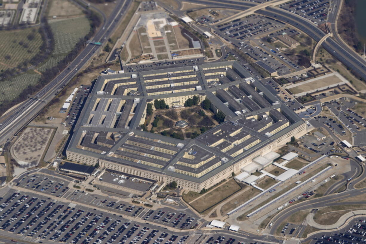 FILE - The Pentagon is seen from Air Force One as it flies over Washington, March 2, 2022. The U.S. military says explosions earlier this month on a base in eastern Syria that injured several U.S. service members were not, as it originally reported, caused by artillery or another form of indirect fire. Instead, it is now believed the April 7 attack was carried out by the "deliberate placement of explosive charges" by one or more individuals at an ammunition holding area and shower facility on the base, according to a statement issued Thursday by the Operation Inherent Resolve command that oversees U.S. military operations against the Islamic State group in Syria and Iraq.