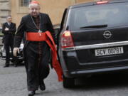 FILE - Cardinal Stanislaw Dziwisz arrives for a meeting at the Vatican, Friday, March 8, 2013. A Vatican investigation into allegations that Dziwisz, the former top aide to St. John Paul II was negligent in handling sex abuse claims in his native Poland has cleared him of wrongdoing, the Vatican's embassy in Poland said Friday, April 22, 2022.