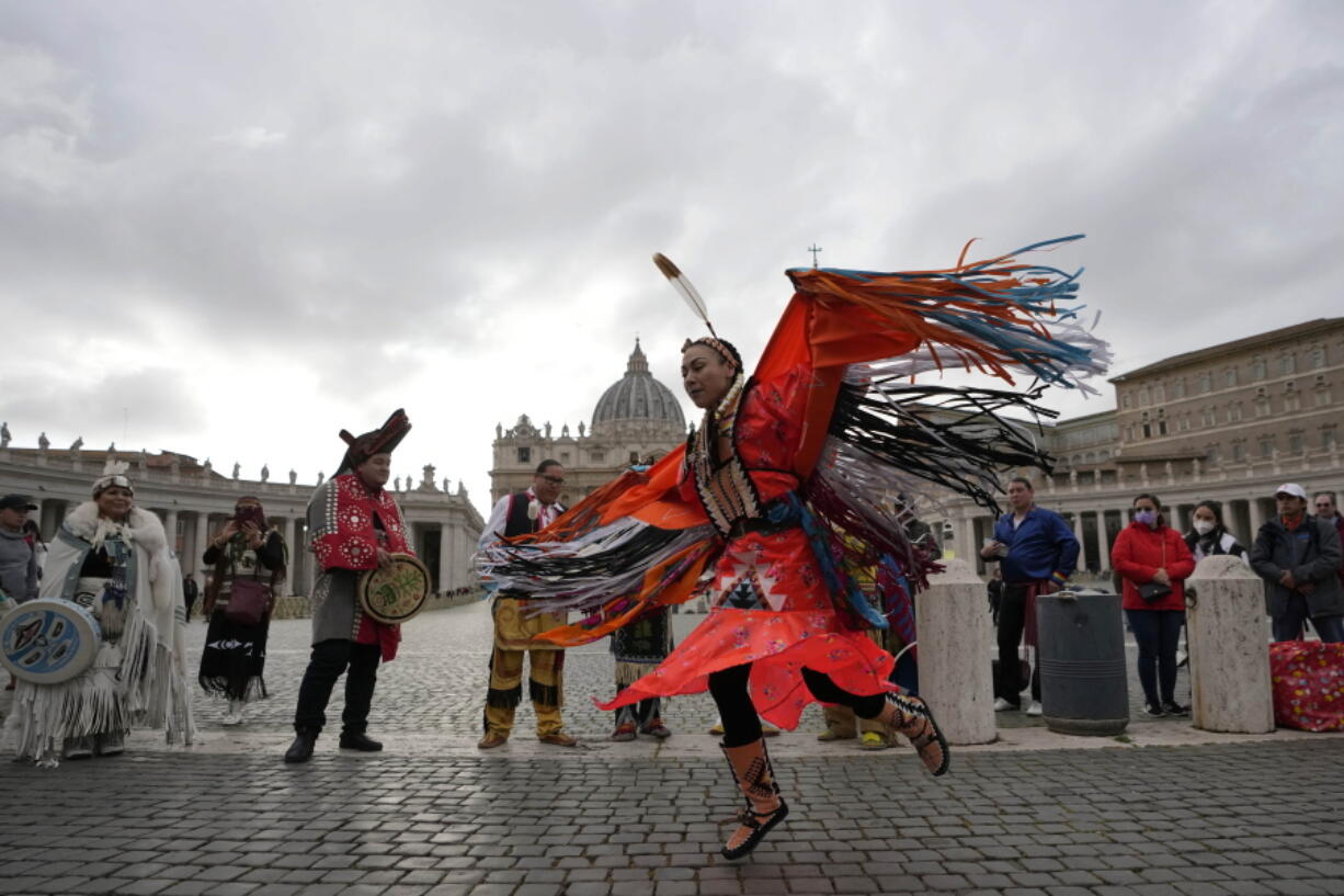 Members of the Assembly of First Nations perform in St. Peter's Square at the Vatican, Thursday, March 31, 2022. Pope Francis has welcomed First Nations delegations to the Vatican. They are seeking an apology for the Catholic Church's role in running Canada's notorious residential schools for Indigenous children.