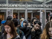 FILE - Students at Stuyvesant High School leave after classes end for the week, March 13, 2020, in New York. Schools across America are racing to make up for lost classroom time, budgeting billions of dollars for tutoring, summer camps and longer school days. But figuring out which students need help has become its own challenge after the pandemic left holes in some students' learning records. New York City is adding three rounds of testing this year, hoping to pinpoint which students are behind and where.