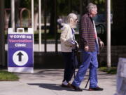 FILE - People leave a testing and vaccination clinic for COVID-19, March 30, 2022, in Long Beach, Calif. While many Americans are trying to move on with their lives after two years of the coronavirus pandemic, U.S. health officials are only beginning to decide on a strategy for using the COVID-19 vaccines to stay ahead of the outbreak. A panel of vaccine experts is meeting Wednesday, April 6, 2022 to discuss key questions for future COVID-19 booster campaigns, including how often the shots should be updated against new viral strains and who should get them.