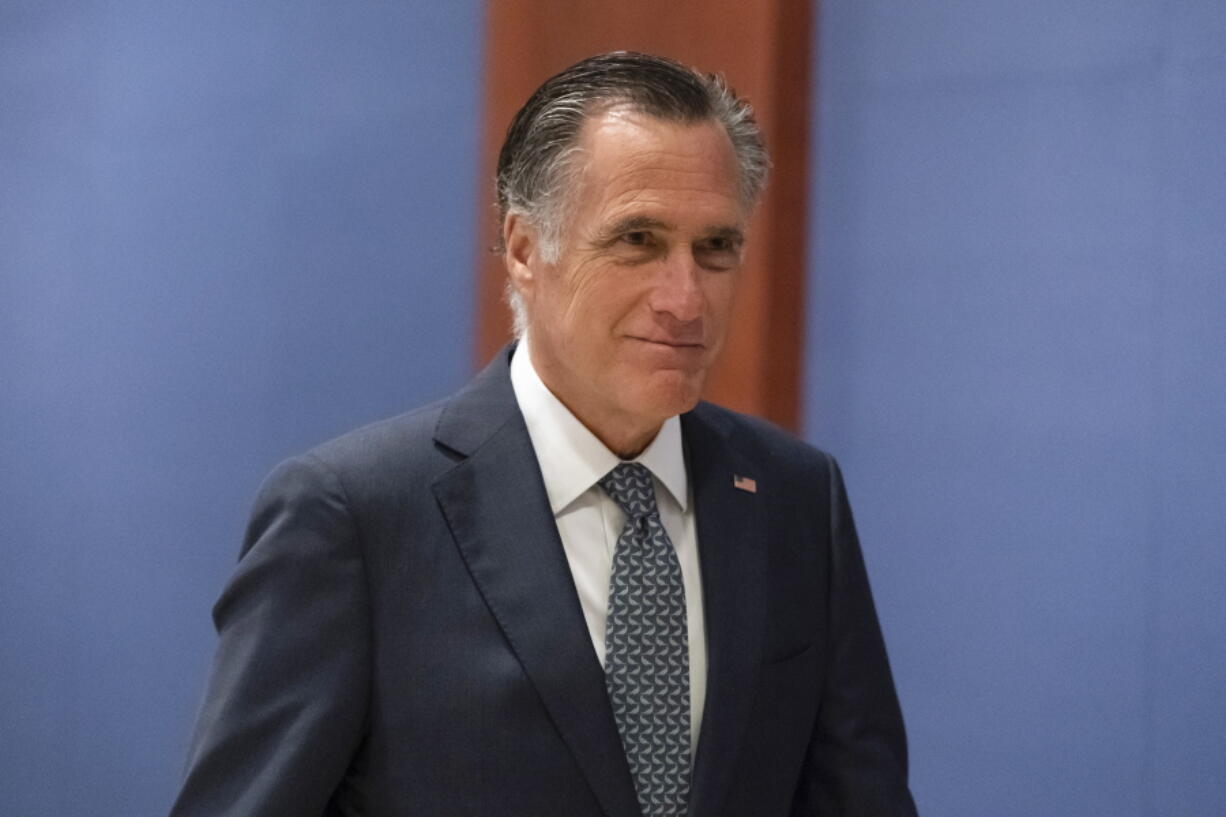 FILE - Sen. Mitt Romney, R-Utah, arrives to watch a speech by Ukrainian President Volodymyr Zelenskyy live-streamed into the U.S. Capitol, in Washington, March 16, 2022. Bipartisan Senate bargainers have agreed to a slimmed-down $10 billion package for countering COVID-19, but without any funds to help nations abroad combat the pandemic, Democrats and Republicans familiar with the talks said Monday, April 4.