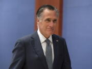 FILE - Sen. Mitt Romney, R-Utah, arrives to watch a speech by Ukrainian President Volodymyr Zelenskyy live-streamed into the U.S. Capitol, in Washington, March 16, 2022. Bipartisan Senate bargainers have agreed to a slimmed-down $10 billion package for countering COVID-19, but without any funds to help nations abroad combat the pandemic, Democrats and Republicans familiar with the talks said Monday, April 4.