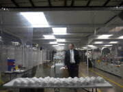 Jim Schmersahl, owner of Halcyon Shades, poses in a "clean room" used in making N-95 masks at the company's production facility Friday, March 18, 2022, in University City, Mo. Halcyon is small company that normally makes window shades, but when the pandemic hit, its sales plummeted. Halcyon applied for the state grants to make PPE as a way to try to keep its employees at work and keep the company afloat.