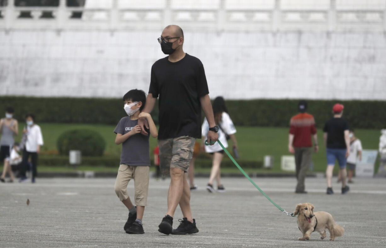 People wear face masks to protect against the spread of the coronavirus in Taipei, Taiwan, Wednesday, April 27, 2022.