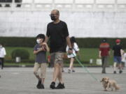 People wear face masks to protect against the spread of the coronavirus in Taipei, Taiwan, Wednesday, April 27, 2022.