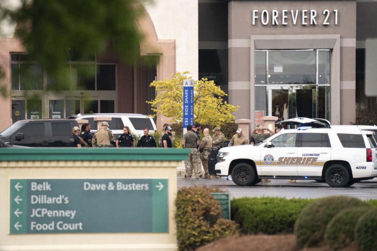 FILE - Members of law enforcement gather outside Columbiana Centre mall in Columbia, S.C., following a shooting, April 16, 2022. Authorities in South Carolina say they are investigating shooting at a club in Hampton County early Sunday, April 17, 2022 that left at least nine people injured. It was the second mass shooting in the state in as many days.