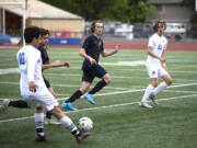 Stadium’s Jeremy Baez flicks a pass forward as Mountain View’s Nolan Brady, second from left, and Jordan Thornton defend in the second half of Saturday’s Class 3A bi-district game at McKenzie Stadium.