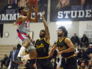 Vancouver Volcanoes guard Devaunte Paschal glides toward the hoop for a layup against Roshun Wynne Jr., center, and Jeremy Ireland of the SoCal Moguls during a game May 6, 2022, at O?Connell Sports Center in Vancouver.