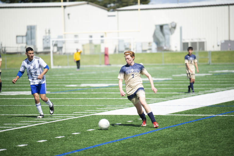 Kaden Bradshaw dribbles the ball during Seton Catholic's 3-0 win over Elma in the 1A boys soccer district championship game on Saturday, May 14, 2022.