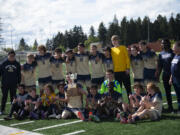 The Seton Catholic boys soccer team poses with the district championship trophy after beating Elma  in the 1A boys soccer district championship game on Saturday, May 14, 2022.