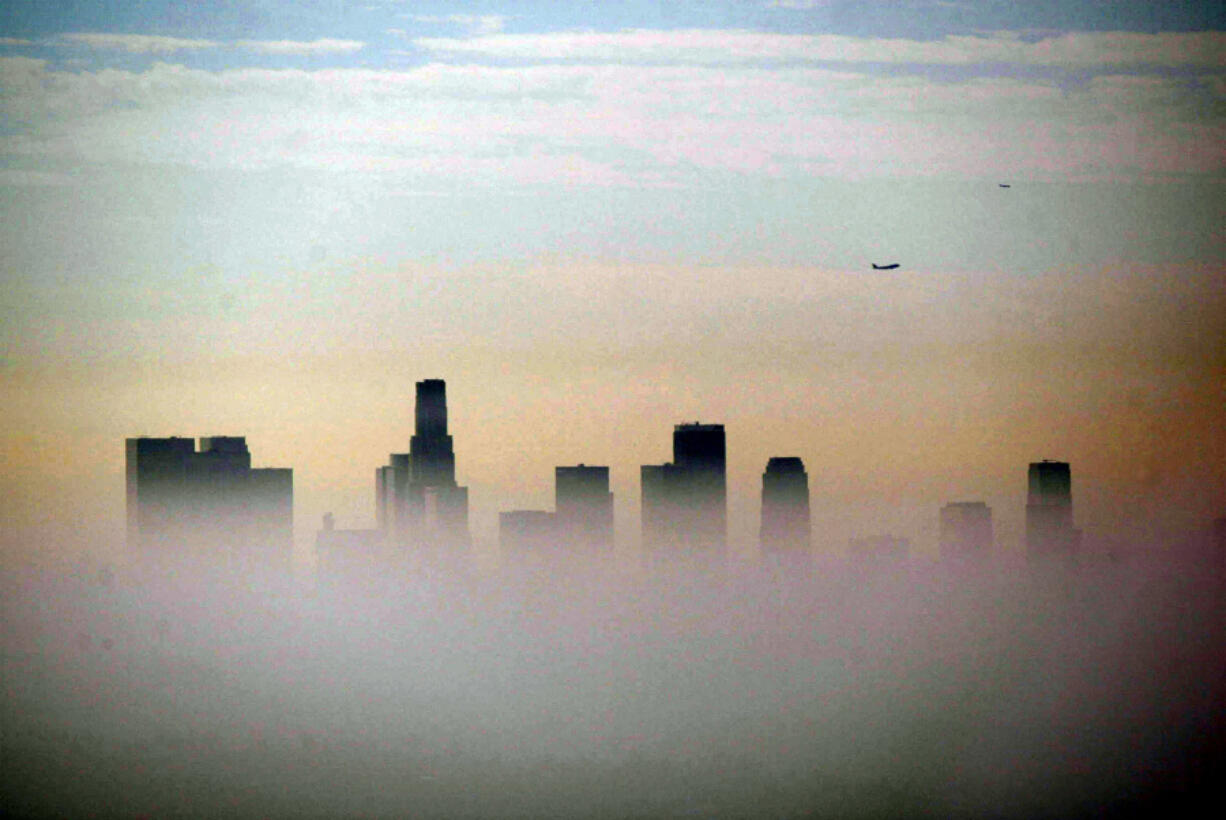 The skyline of downtown Los Angeles is partially obscured by a smoggy haze in 2019.