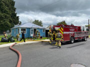 Clark-Cowlitz Fire Rescue firefighters enter a burning house in Woodland on Wednesday afternoon to search for three pets inside.