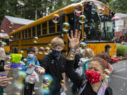 Students including first-grader Trulee Dunn, right, get a warm goodbye from teachers and staff as they prepare to board the bus on the last day of class at Green Mountain School on Tuesday morning, June 15, 2021. Photographer Amanda Cowan earned a second place award for features photography in the Society of Professional Journalists contest.