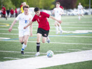 Fort Vancouver's Ernesto Coria Zavala (1) works against Ridgefield's Ashton Wagner during the Trappers' 2-0 win over Ridgefield in 2A boys soccer district playoff on Saturday, May 14, 2022.