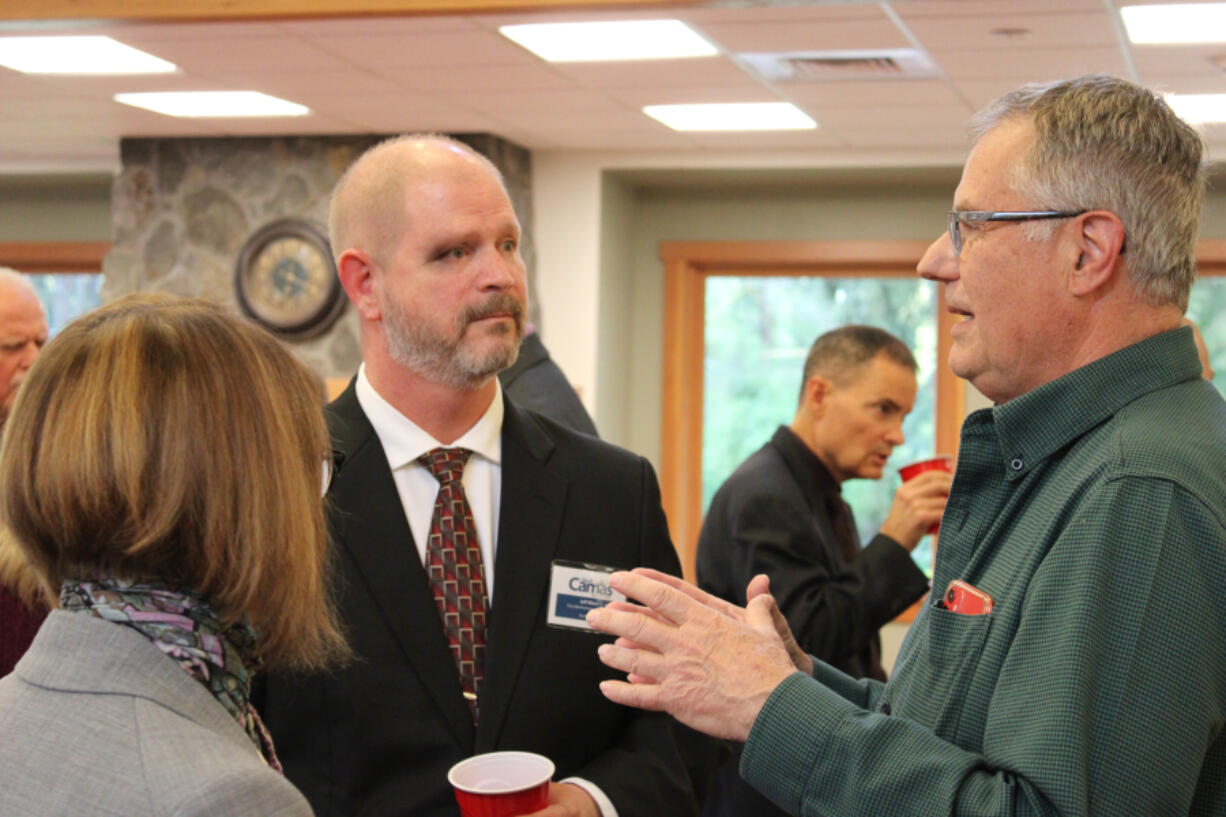 Jeff Niten, city manager for the city of Shelton, one of four applicants being considered as the city of Camas' next city administrator, speaks with the Downtown Camas Association Board of Directors' president, Sarah Laughlin, and vice president Randy Curtis during an open house at Lacamas Lake Lodge in May.