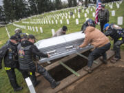 Patriot Guard Riders prepare to lower the casket of Francis E. Dick into his gravesite at the Fort Vancouver Military Cemetery on Feb. 13, 2019. The group will do as much or as little as the family asks, Patriot Guard Rider Lynn Vaughn said.