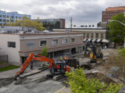 Construction crews work on a sewer and water line project on Broadway in downtown Vancouver on Thursday. Phase 2 of the corridor project, which began in mid-February, is anticipated to be completed in June. The timeline is causing concern among the shops in the area, as they have faced significant drops in business since it began. Phase 1 was completed in 2021.