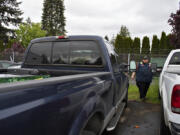 Jake Beals, lead driver for Triple J Towing, looks over stolen pickups Monday morning in the company's Vancouver lot. Beals said Triple J responded to 47 calls for stolen vehicles at its three lots in April.