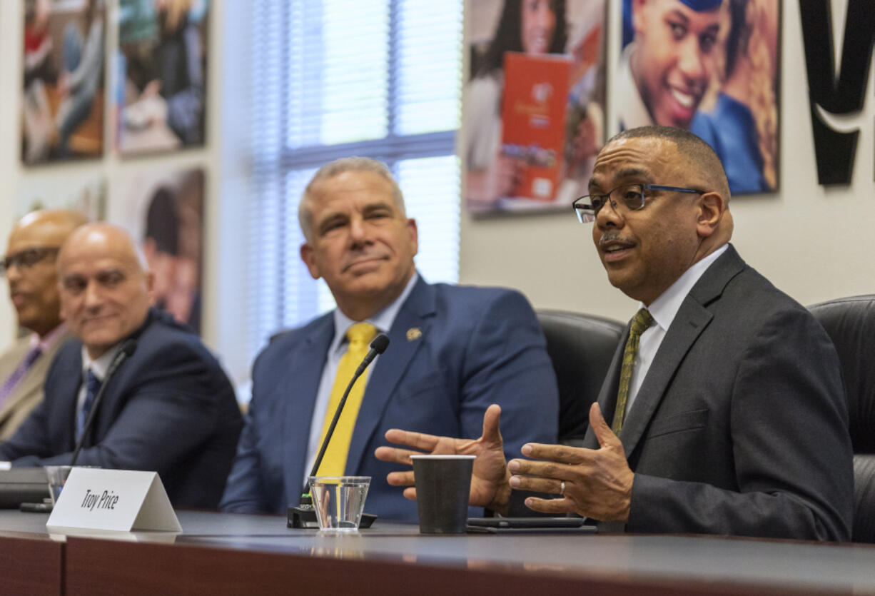 Vancouver police chief candidate and current Vancouver Assistant Police Chief Troy Price, right, introduces himself Tuesday during a community Q&A session. The chosen candidate will replace current police Chief James McElvain, who is slated to retire June 30.