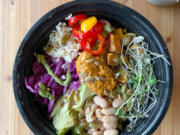 River Maiden's Amaze Bowl combines rice, white beans, cilantro garlic sauce, avocado, pickled cabbage, sliced sweet peppers, sweet potato, red pepper pesto and toasted seeds. The bowl also features micro greens from Red Truck Farm.