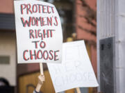 Local abortion rights supporters wave signs Tuesday evening.