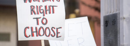 Local abortion rights supporters wave signs Tuesday evening.