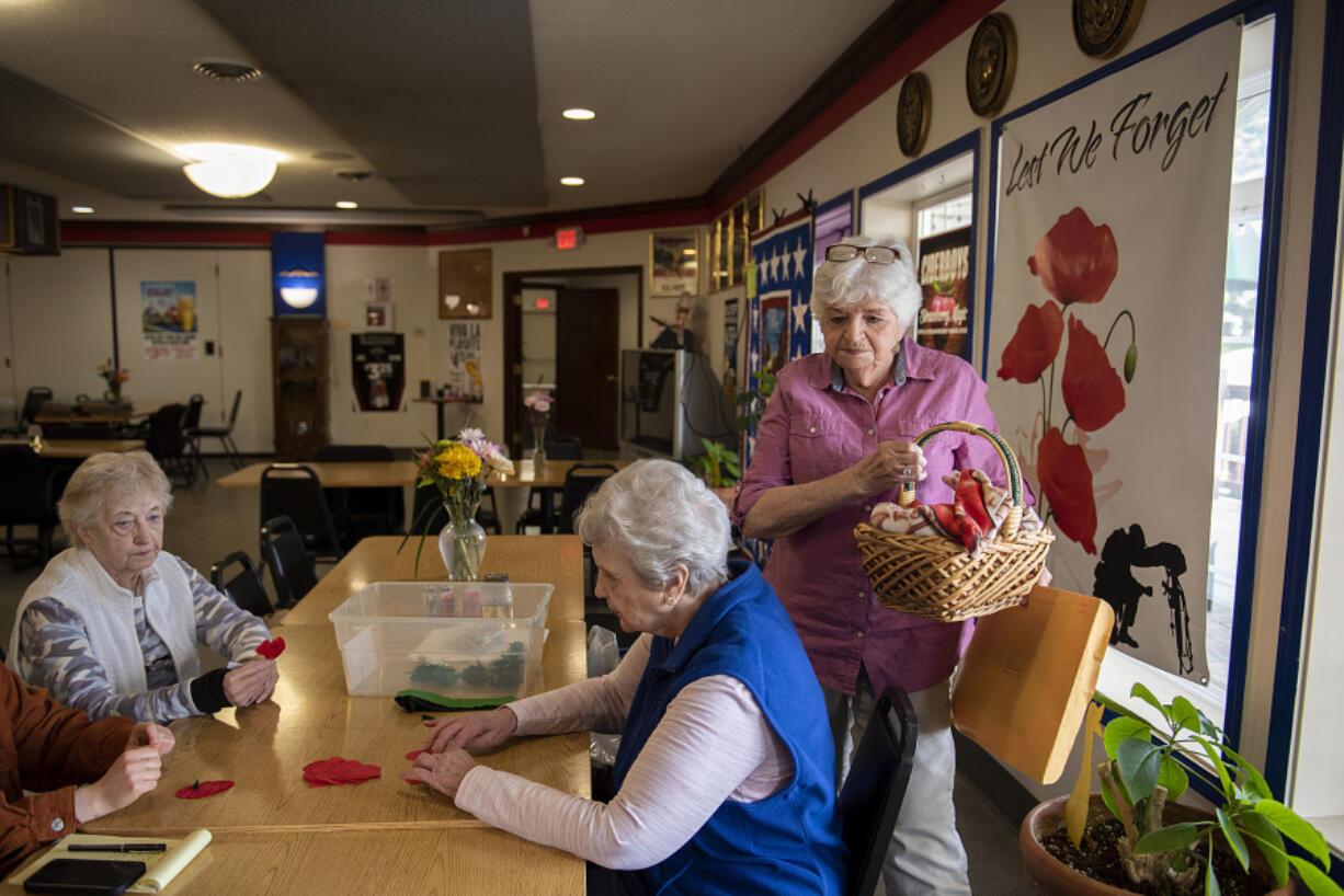 American Legion Auxiliary Smith-Reynolds Post 14  members Audrey Hoff, from left, Claudette Bevill and Sharon Dow outline the process of crafting and selling poppies in preparation for National Poppy Day. The annual recognition occurs every Friday before Memorial Day, which is May 27 this year.