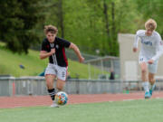 Union's Garik Shevchuk cahses down a ball after beating Olympia's Oliver Dickson in a 4A District 3/4 boys soccer game on Saturday, May 7, 2022, at McKenzie Stadium. Union beat Olympia 1-0 to secure its first state berth since 2016.