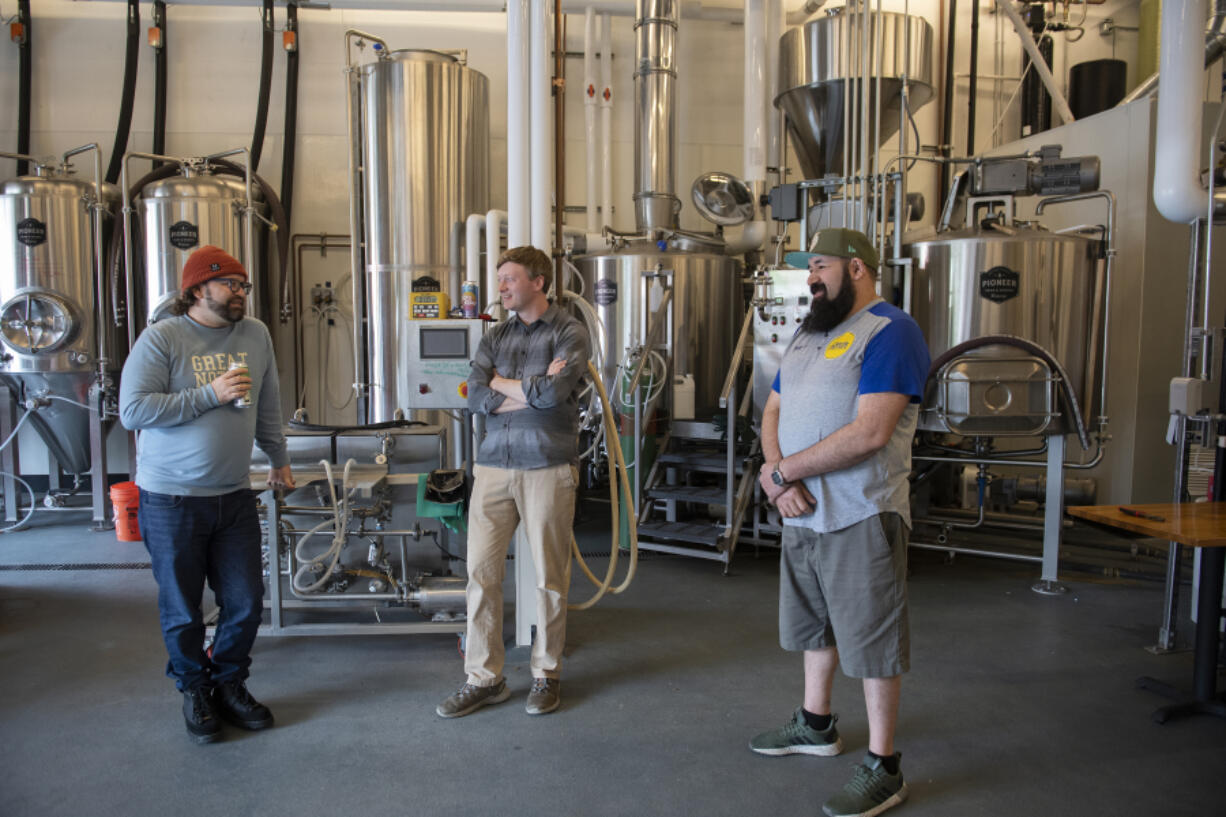 Michael Perozzo, from left, and Cameron Johnson of Vice Beer chat with Eldy Prado of El Viejon Taqueria & Mariscos in the former Barlow's Brewing location in southeast Vancouver.