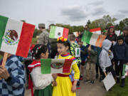 Harney Elementary School third-graders Amber Kanekoa, 8, in green skirt, and Emily Perez, 9, right in yellow, join classmates during the annual Children's Culture Parade at Fort Vancouver National Historic Site on Friday morning, May 13, 2022. The National Park Service and the Evergreen and Vancouver School Districts hosted the annual event.