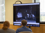 Defense attorney Shon Bogar, left, joins defendant Zachery Hansen as they watch surveillance video during his attempted murder trial Monday morning at the Clark County Courthouse. Hansen is charged with two counts of second-degree attempted murder and two counts of first-degree attempted assault.