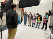 Columbian photojournalist Taylor Balkom works in The Columbian's photo studio on May 4 with staff members Amy Libby, from left, Mark Bowder, Monika Spykerman, Scott Hewitt and Erin Middlewood.