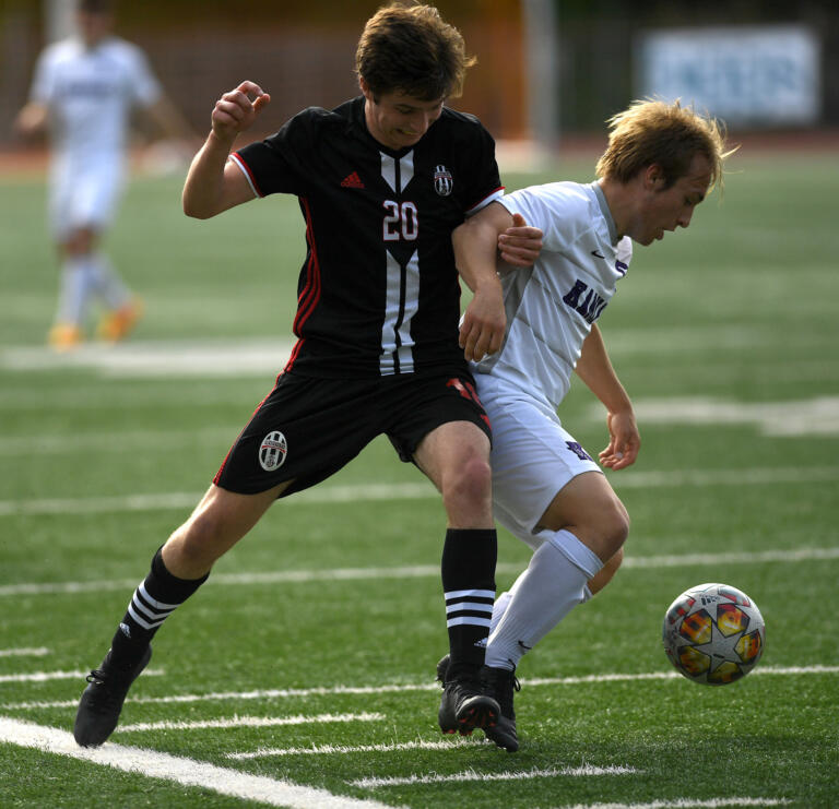 Union senior Josh Boda, left, tries to keep the ball from Kamiak senior Aidan Drought on Wednesday, May 18, 2022, during the Titans’ 1-0 loss to Kamiak in the first round of the 4A state playoffs at McKenzie Stadium.