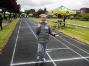 Colton McCurdy, 12, of Puyallup is all smiles while crossing the finish line during the 50-meter dash at the Washington State School for the Blind on Thursday morning. Special wires running along each lane of the track guide competitors with visual impairments from start to finish, an element not available at typical track meets.