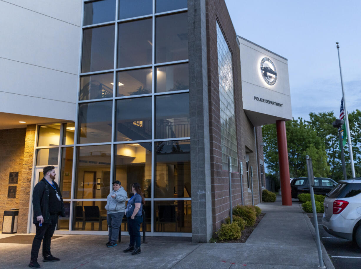 Crisis Support Specialists Bryan Rippentrop, left, Trista Rust, center, and Clinical Supervisor Dawn Tec Yah chat Wednesday outside the Battle Ground Police Department before a shift on Columbia River Mental Health Services' Mobile Night Crisis team. The service was launched on May 15, and aims to provide direct mental health counseling and treatment to vulnerable individuals and relieve law enforcement and emergency service personnel from the need to respond to mental health and substance use crises overnight. At top, a logo identifies the Columbia River Night Crisis team's mobile health van.