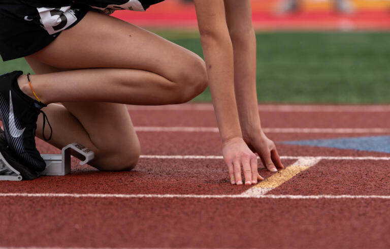 Washougal's Jamie Maas positions her hands on her mark before the start of the 2A Girls 400 at the 4A/3A/2A State Track and Field Championships on Saturday, May 28, 2022, at Mount Tahoma High School in Tacoma.