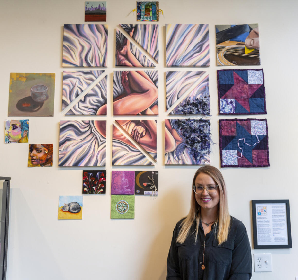 Vancouver-based artist Sarah Lynne Hunter stands beneath the community quilt-inspired art exhibit at Dandelion Teahouse. The centerpiece was created by Hunter and surrounding squares will be contributed by community members.