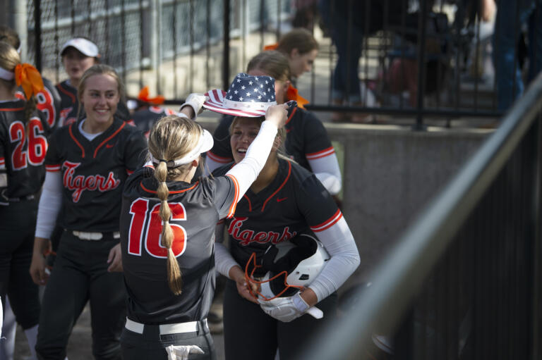 Battle Ground's Cady Gruenberg has the Tigers' home run hat placed on her head after hitting a home run in the Tigers' 21-0 win over Curtis in the 4A bi-district softball tournament in Auburn on Friday, May 20, 2022.