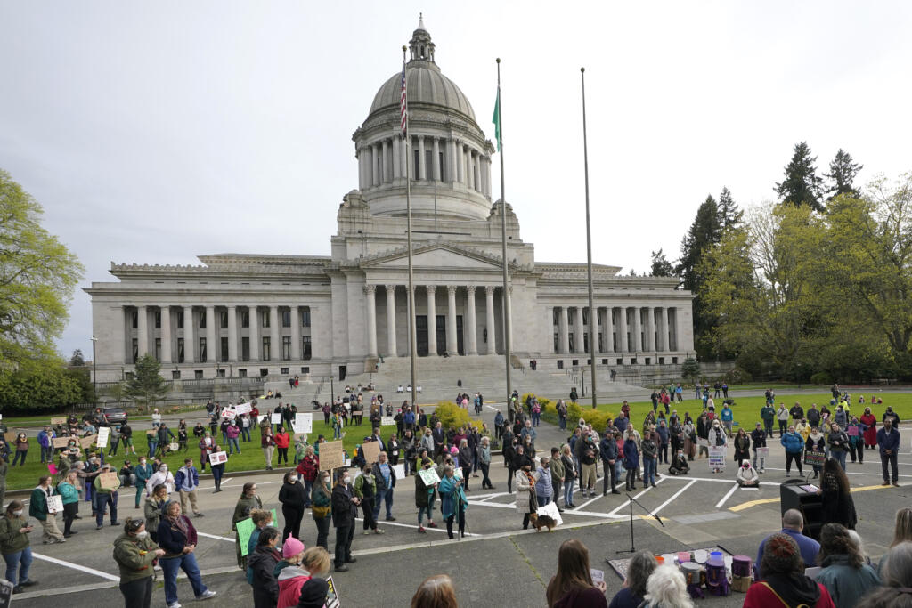 People demonstrating in favor of abortion rights gather during an evening rally, Tuesday, May 3, 2022, at the Capitol in Olympia, Wash. (AP Photo/Ted S.