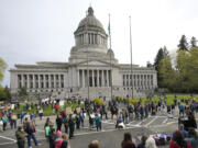 People demonstrating in favor of abortion rights gather during an evening rally, Tuesday, May 3, 2022, at the Capitol in Olympia, Wash. (AP Photo/Ted S.