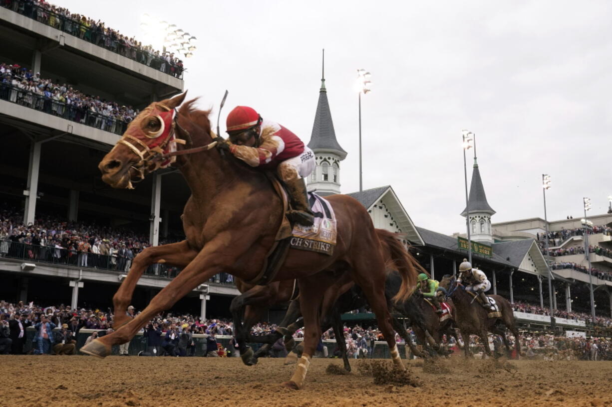 Rich Strike (21), with Sonny Leon aboard, wins the 148th running of the Kentucky Derby horse race at Churchill Downs Saturday, May 7, 2022, in Louisville, Ky.